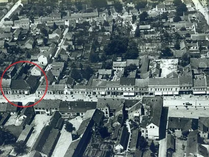 Na fotografiji Daruvara snimljenoj iz zraka 1962 godine vidimo da su četiri prozora do tadašnje Radićeve promijenjena u vrata, odnosno izloge s tendom. U stambenom dijelu kuće stanuje obitelj Muić, u poslovnom su različiti lokali, odnosno trgovine i skladišta/Foto: Milan Pavić